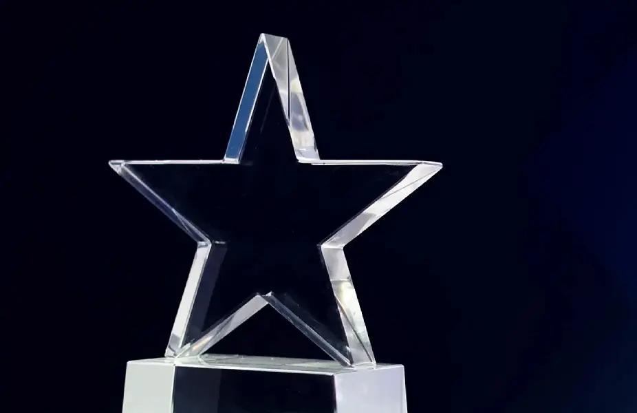 A crystal star award is set against a dark blue background.