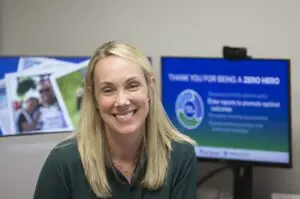 A blonde woman sits in her Bon Secours office.