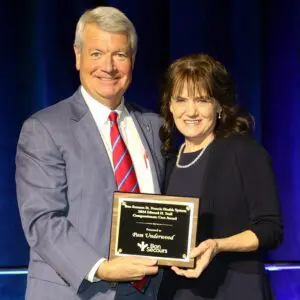 Fred Gilmer presenting Pam Underwood with a Compassionate Care Award.