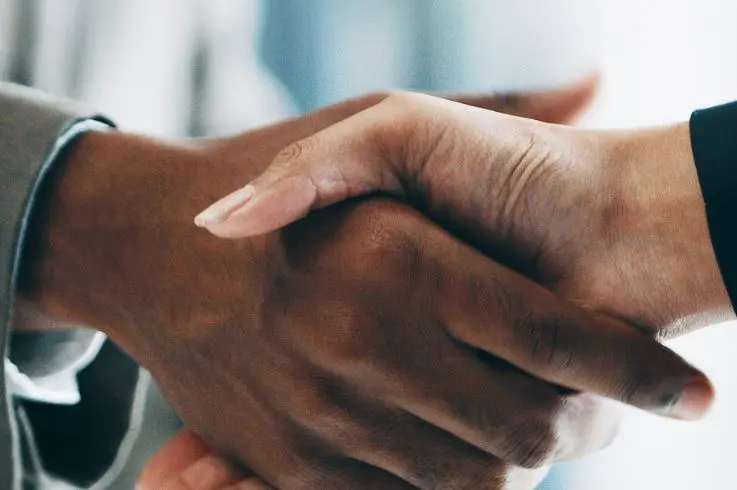 A closeup of a handshake between two business people.