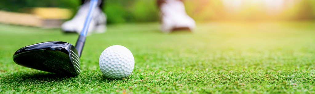 A golfer lining up a shot on the green.