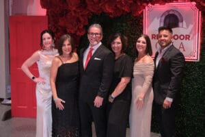 A group of people pose for a photo at the Red Door Gala