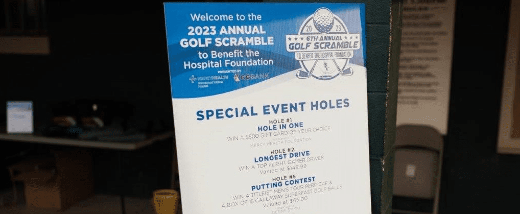 A poster board listing the special event holes at a golf event.
