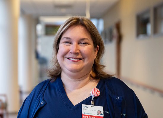 A young nurse stands in the hallway of Mercy Health Fairfield Hospital.