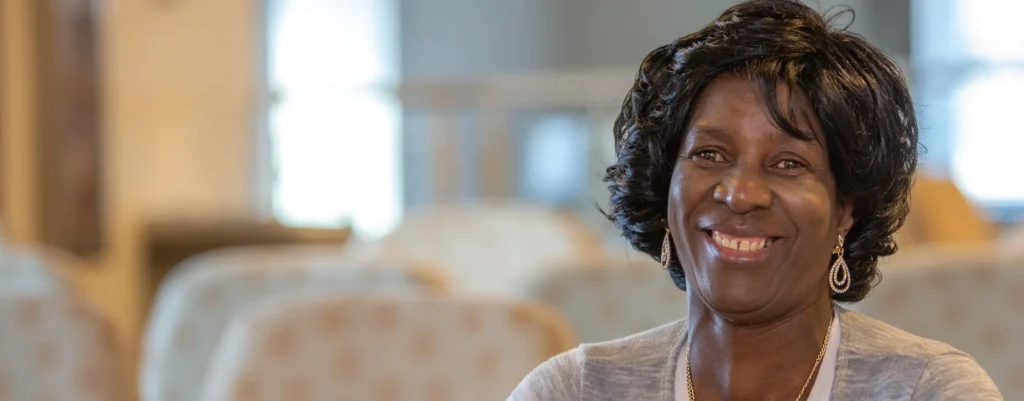 A photo of an older Black woman smiling.
