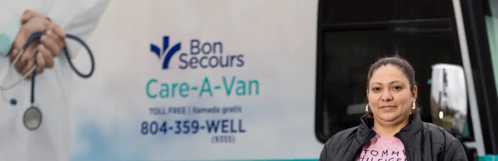 A young mother stands outside the Bon Secours Care-a-Van in Richmond, VA.