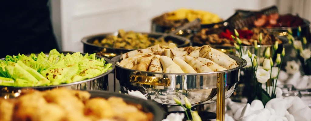 A banquet table full of catering food.