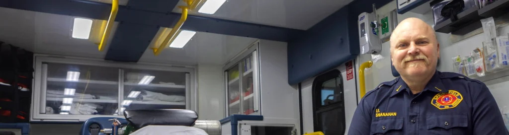 An EMS officer sits inside an ambulance.