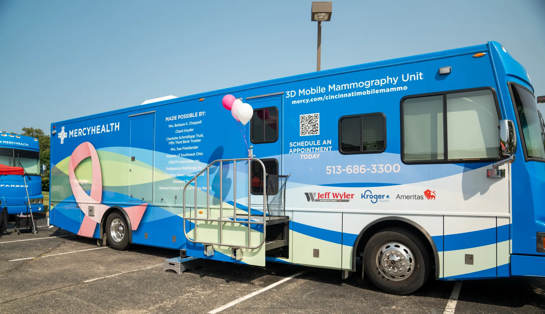 A Mercy Health-branded mobile coach is parked to receive patients for screenings.