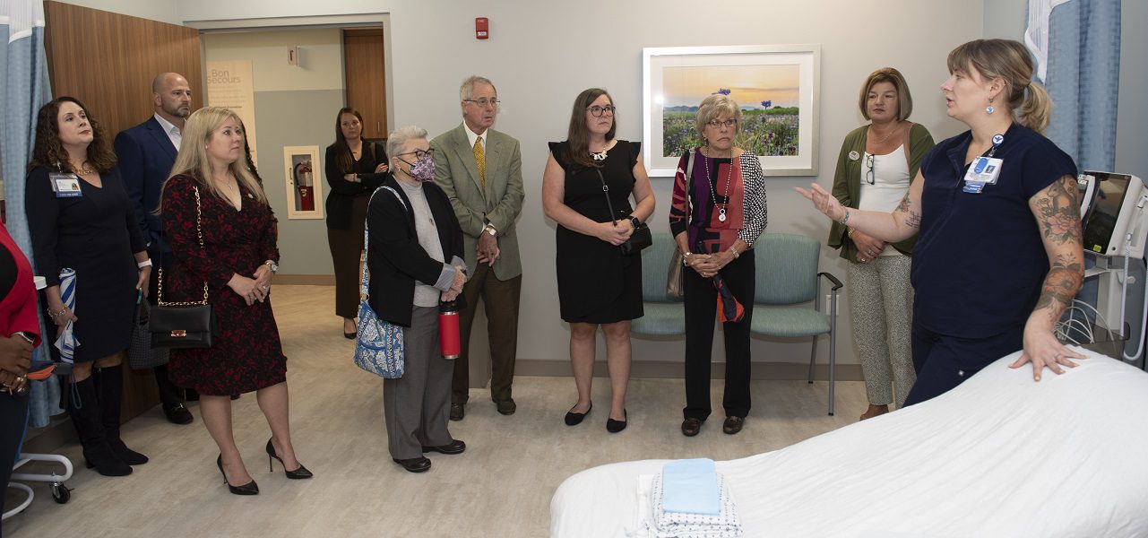 A group of business people tours a medical facility.