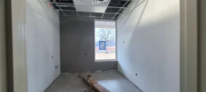 The inside of an exam room at a medical facility that is under construction.