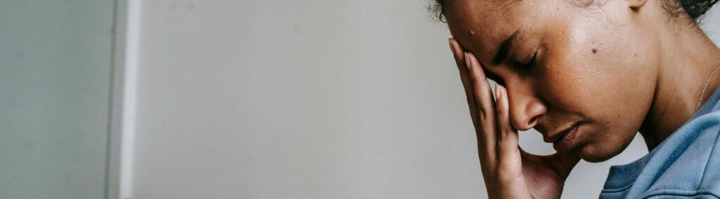 A woman with her face buried in her hand