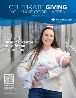 Smiling woman holds a newborn baby under a Mercy Health Celebrate Giving banner; caption reads: 'Your gift gave Mackenzie tools for an easier labor.'