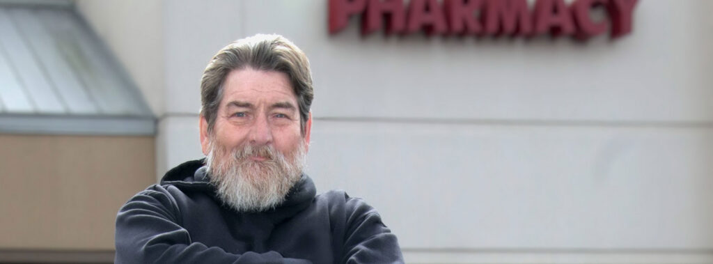 Samuel Bryant stands outside pharmacy