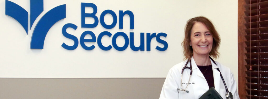 Dr Julie Dangler standing by bon secours sign