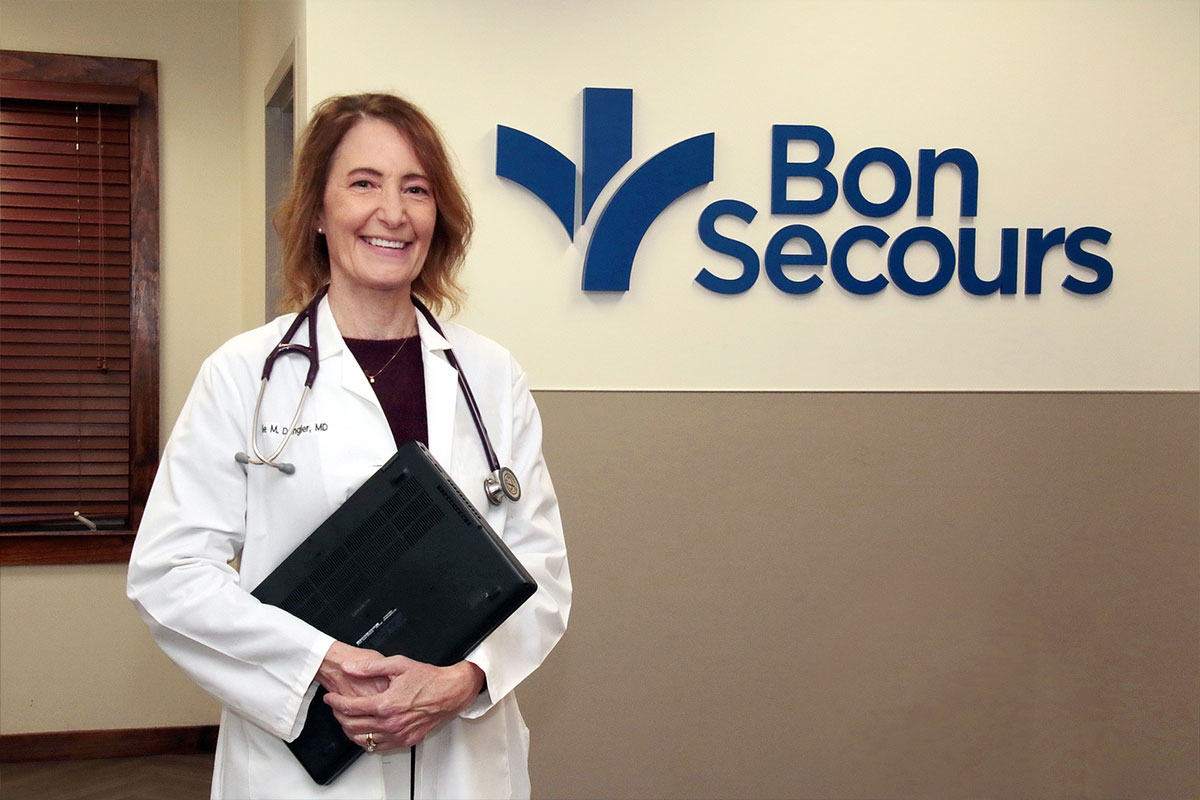 Dr Julie Dangler standing by bon secours sign