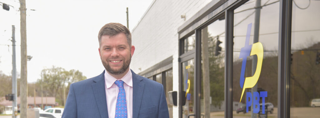 Justin Dixon standing outside bank