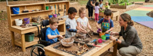 Children at the sensory outdoor discovery table