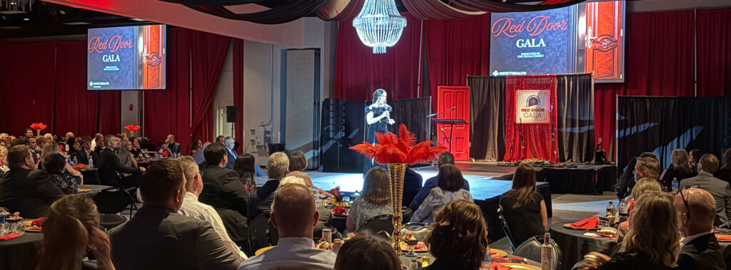 Wide view of stage and tables at the Red Door Gala 2026
