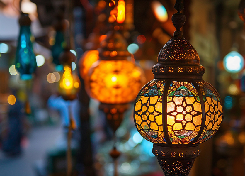 Colorful Moroccan Lanterns lit up at night blurring into the background