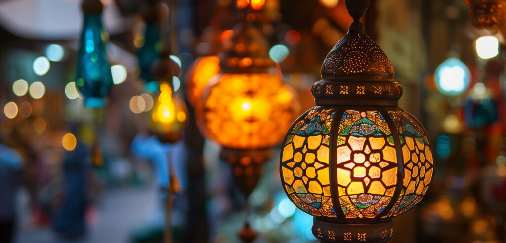 A line of Moroccan Lanterns lit up at night blurring into the background.