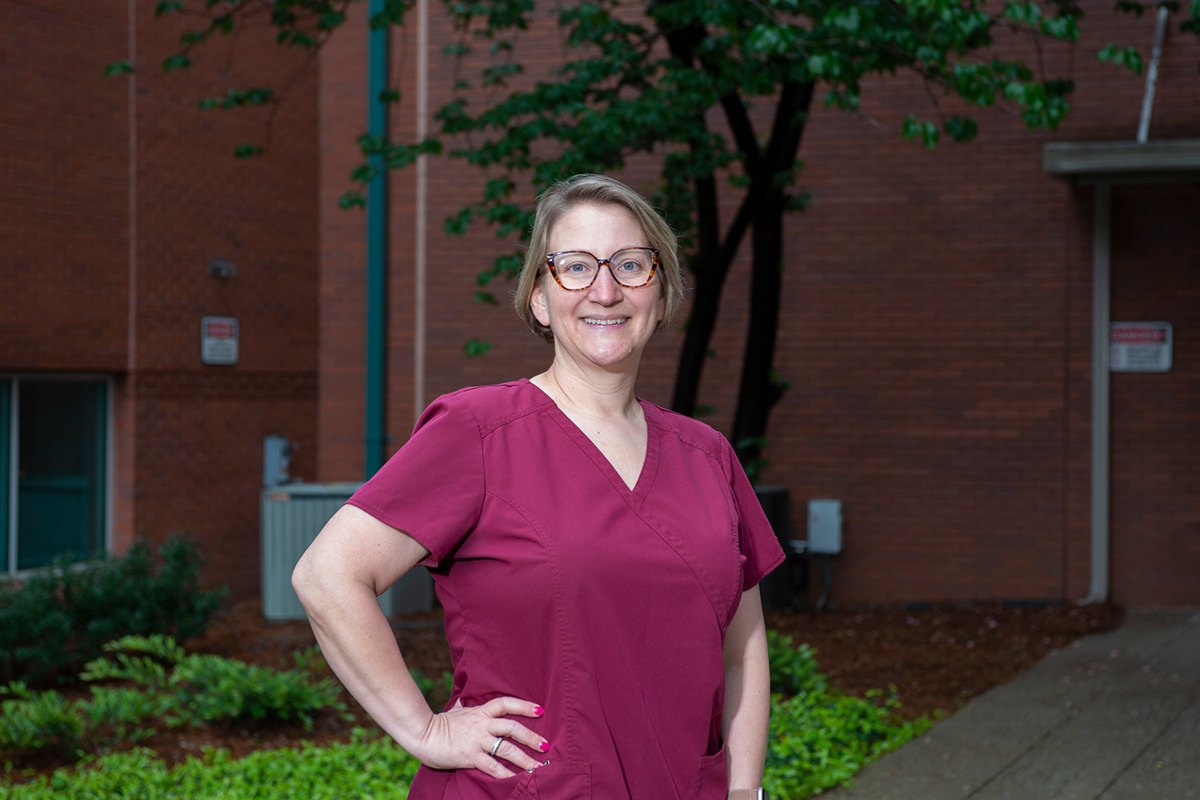 Headshot of Amanda in her scrubs outside the clinic