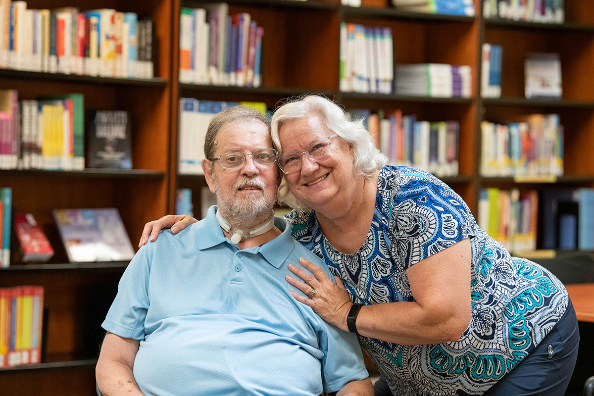 Jane and John with shelves of books in the background
