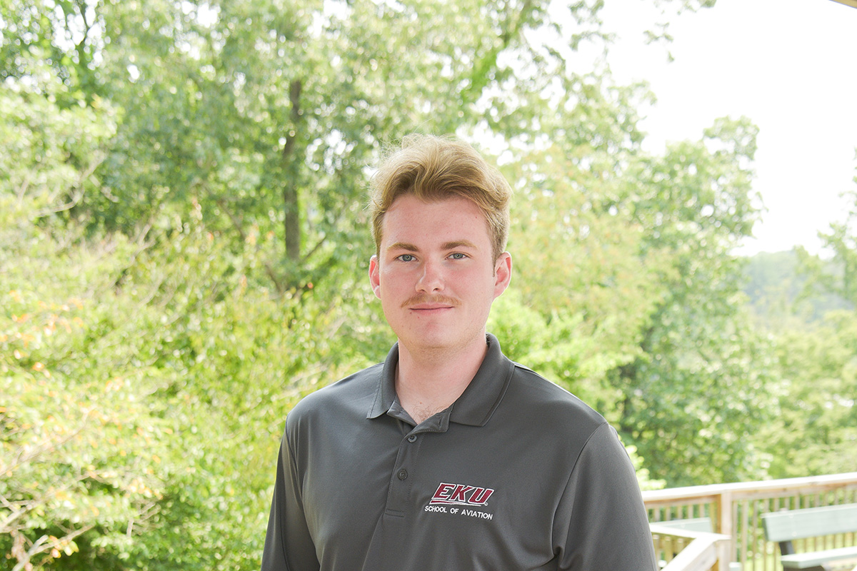Headshot of Greg Stocker with trees in the background