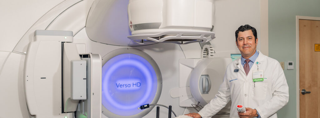 Dr Barron next to a radiation equipment