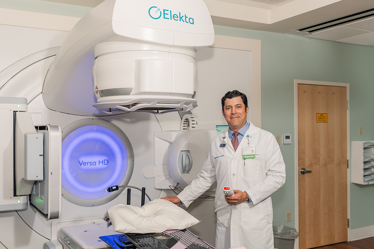 Dr Barron next to a radiation equipment