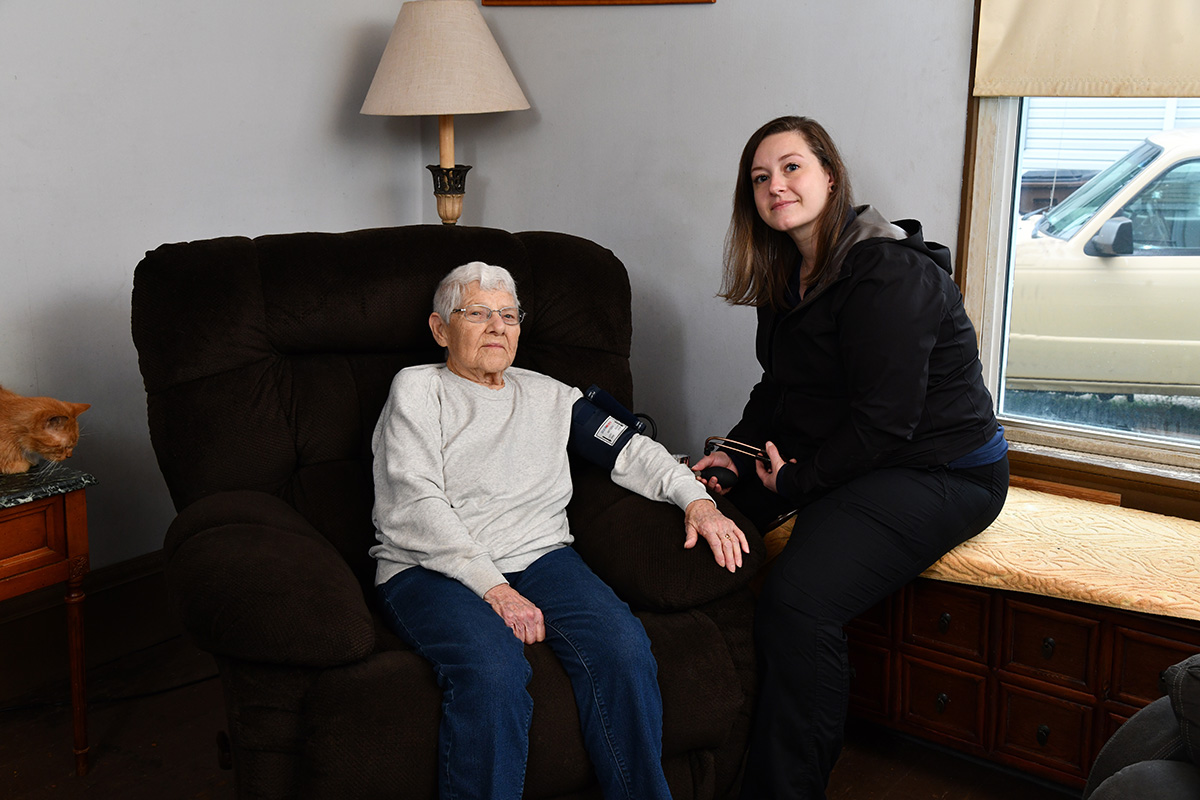 Nancy Douglas in her home with a paramedic