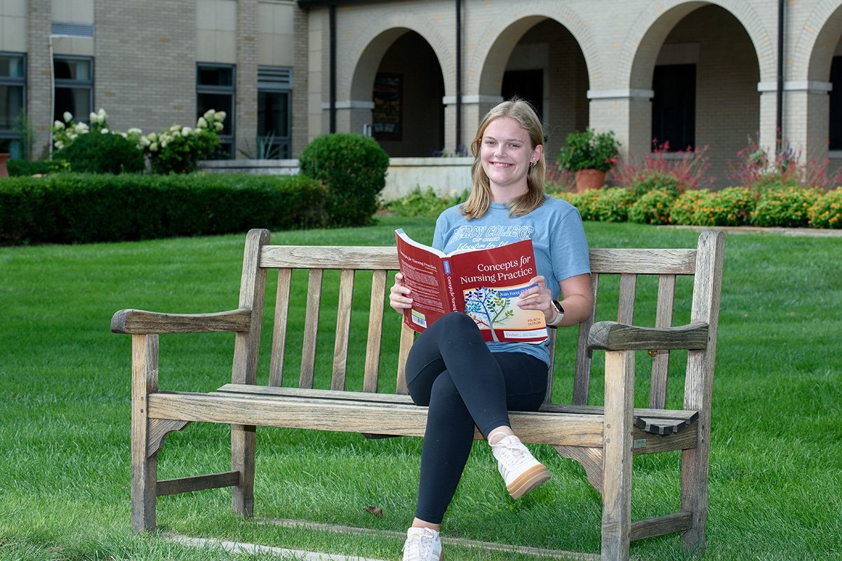 Ashley Wagner outside with a school book