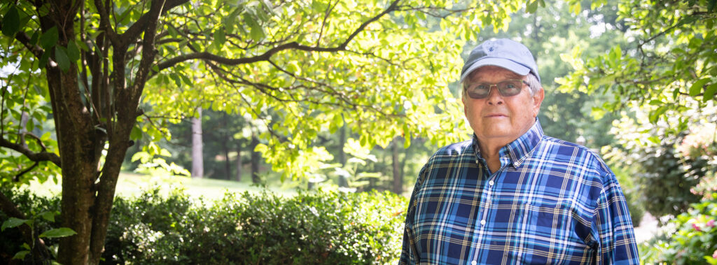 Harold Hempfling headshot with a trees and bushes in the background