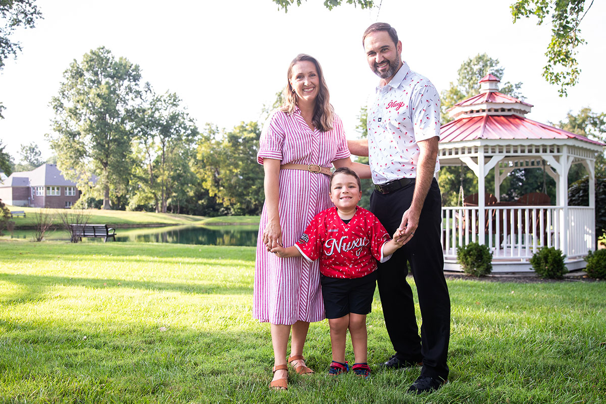 Sam and his family standing outside in park
