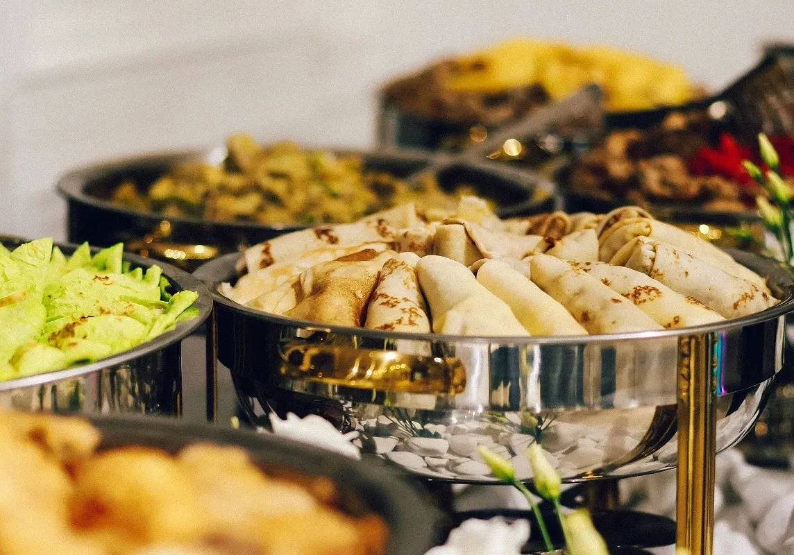 A banquet table full of catering food.