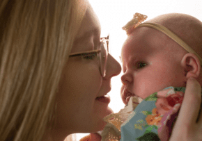 A young mother holds her newborn baby up for a kiss at Mercy Health Lourdes Little Miracles Birthing Center.