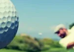 Golfer hits a golf ball
