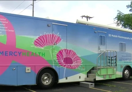 The Mercy Health Greater Toledo Mobile Mammography van stationed in a parking lot on a sunny summer day.
